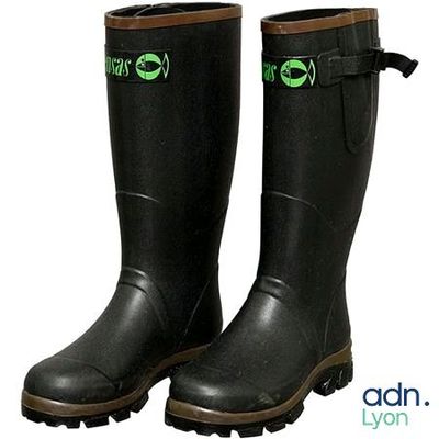 two pairs of black rain boots with green eyes on them