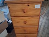 a wooden chest of drawers in a room with a blue chair