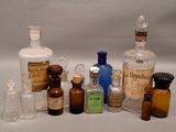 bottles of various sizes and shapes are lined up on a white surface