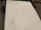 a couch that has a mattress on it in a room