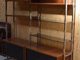 a large display case with shelves and speakers in a room