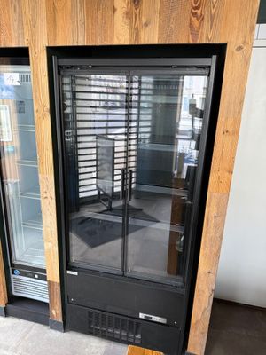 a glass door that is open on the outside of a building