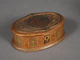 a small wooden box with a decorative design on it