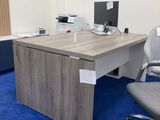 a desk with a chair and a computer on it