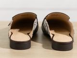 the shoes are lined up on a wooden table with a white wall in the background