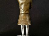 statue of a girl holding a red heart in her hands