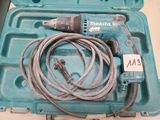 une mallette bleue contenant un cordon et une perceuse