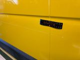 a close up of a yellow van with a sticker on it