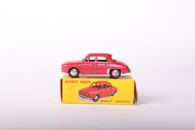 a red toy car sitting on top of a yellow box