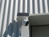 an image of a security camera mounted on the side of a building