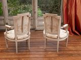 two chairs that are sitting in front of a window