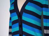 a woman ' s blue and black striped cardigan sweater on a mannequin mannequin mannequin mannequin mannequin mannequin mann
