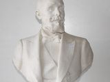 a bust of a man in a tuxedo sitting on a table
