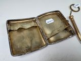 a silver case with a pair of scissors inside of it