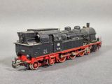 a black and red train engine on a gray surface