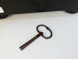 a key that is laying on a table