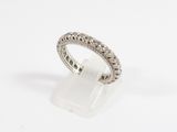 a close up of a diamond ring on a white surface