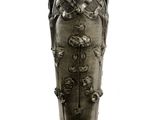 a silver vase with a design on it on a white surface