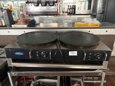 two pans sitting on top of a stove in a kitchen