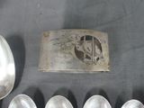 several spoons and spoon rest on a table with a picture of a woman