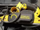 a yellow and black tool sitting on top of a black box