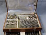 a wooden box with silverware in it on a table