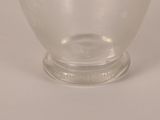 a clear glass bowl with a lid on a white surface