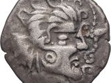 une pièce d'argent sur laquelle figure un visage