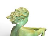 a statue of a woman sitting on a chair