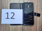 an image of a cell phone sitting on top of a table next to a paper