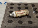 a tube of glue sitting on top of a piece of foam