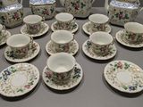 a lot of cups and saucers that are on the table