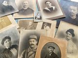 several old black and white photos of men and women on a table