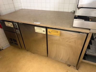 a stainless steel counter top in a kitchen with a dishwasher and oven