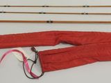 a lot of fishing rods and a pair of pants on a table