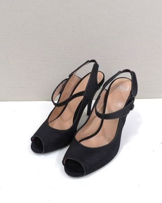 a pair of black high heeled shoes with straps on the toes