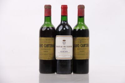 three bottles of wine sitting next to each other on a white surface