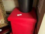 three red boxes stacked on top of each other in front of a picture