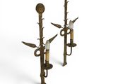 a pair of brass candles with birds on them on a white background