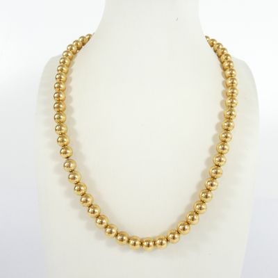 a gold beaded necklace on a mannequin mannequin mannequin mannequin mannequin mannequin mannequin mannequin mann