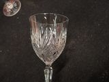 a wine glass sitting on a table next to a wine glass