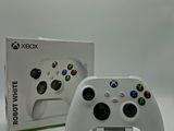 xbox wireless controller and box on white surface with white background