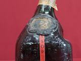 bottles of liquor sitting on a red surface with a red background