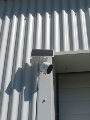 an image of a security camera mounted on the side of a building