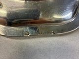 a close up of a silver plate on a table