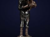 a bronze statue of a boy holding a water jug