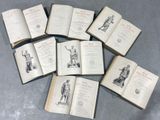 several open books sitting on top of a table next to each other