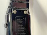 a close up of a wrist watch on a white surface