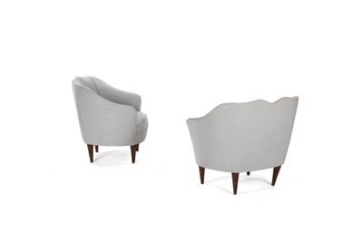 a pair of grey chairs sitting next to each other on a white surface