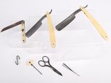 several different types of scissors and a pair of scissors on a table